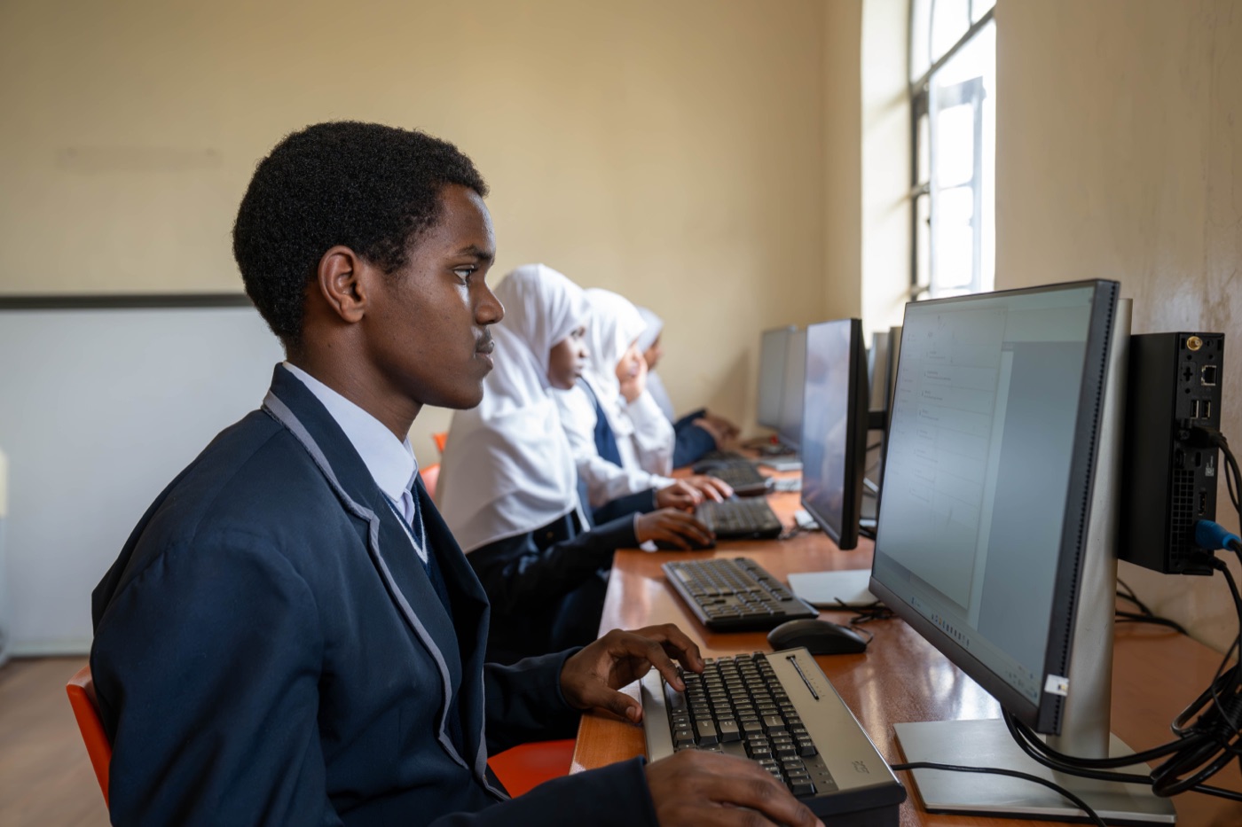 Pupils at desktop computers in the ICT laboratory at Huda Integrated School