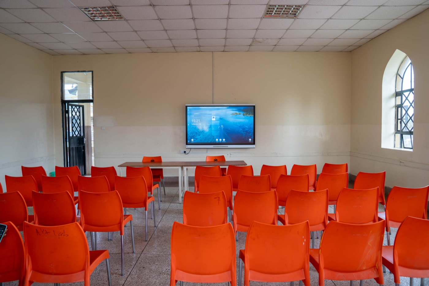 The meeting room at Huda Integrated School, set up with a screen and seating for a discussion