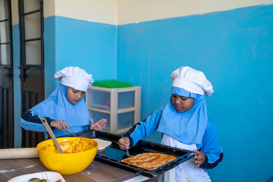 Pupils cooking together at Huda Integrated School
