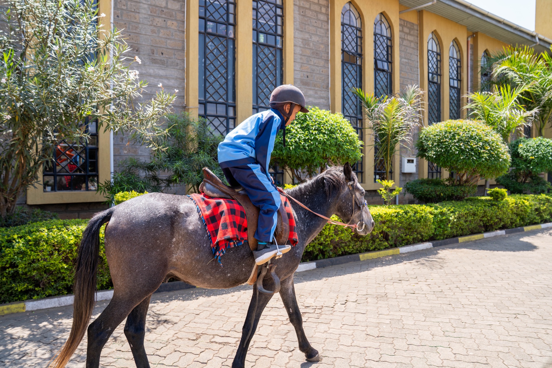 A pupil horse riding at Huda Integrated School