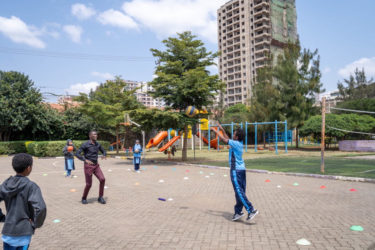 Pupils playing volleyball at Huda Integrated School